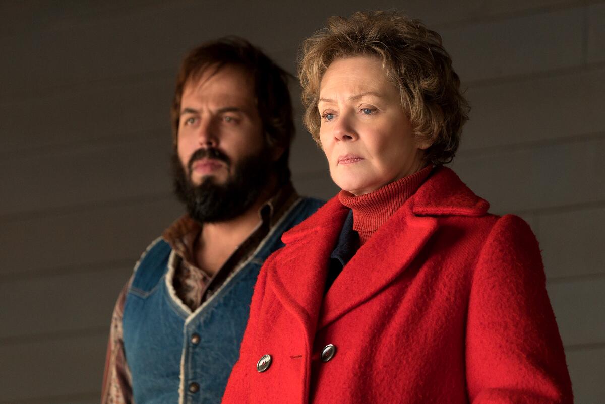 A man and older woman stand side by side looking serious in "Fargo," Season 2.