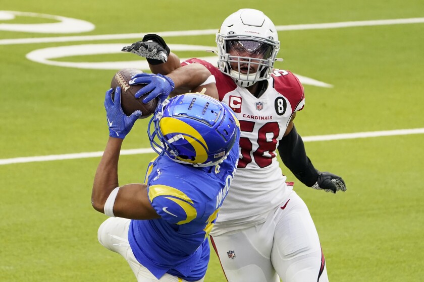 Los Angeles Rams wide receiver Robert Woods, left, catches a pass against Arizona Cardinals middle linebacker Jordan Hicks (58) during the first half of an NFL football game in Inglewood, Calif., Sunday, Jan. 3, 2021. (AP Photo/Jae C. Hong)