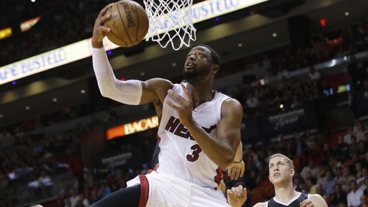 Miami Heat guard Dwyane Wade puts up a shot over Brooklyn's Mason Plumlee in a Miami win Jan. 4.