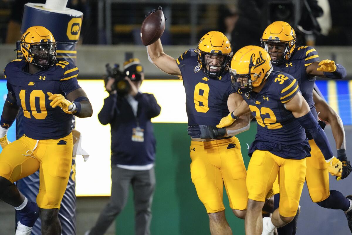 California linebacker Jackson Sirmon celebrates with teammates after scoring a touchdown.