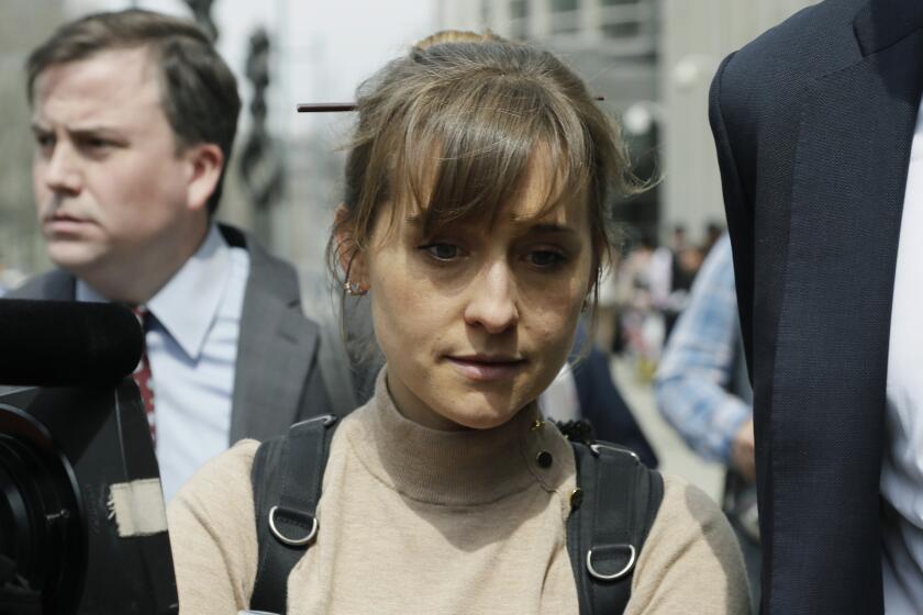 FILE - In this Monday, April 8, 2019, file photo, actress Allison Mack leaves Brooklyn federal court in New York. Mack, who played a key role in a scandal-ridden, cult-like upstate New York group, is facing sentencing Wednesday, June 30, 2021, after pleading guilty to charges she manipulated women into becoming sex slaves for the group’s spiritual leader. (AP Photo/Mark Lennihan, File)