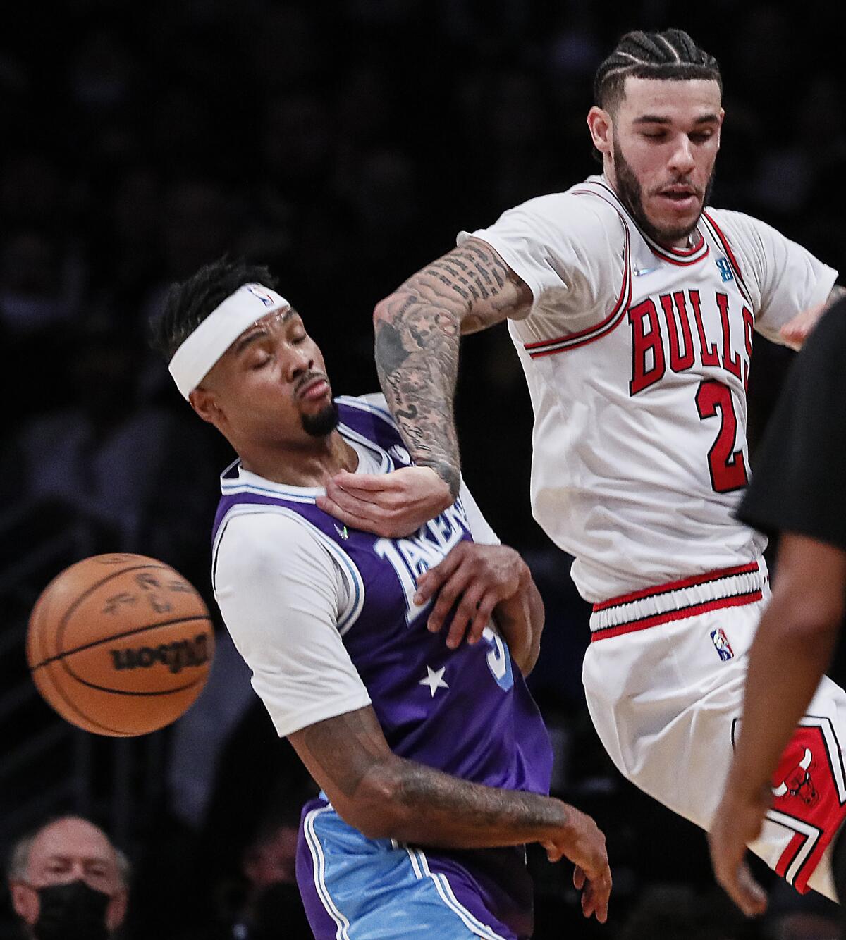 Bulls guard Lonzo Ball (2) saves the ball from going out of bounds while pressured by Lakers guard Talen Horton-Tucker.