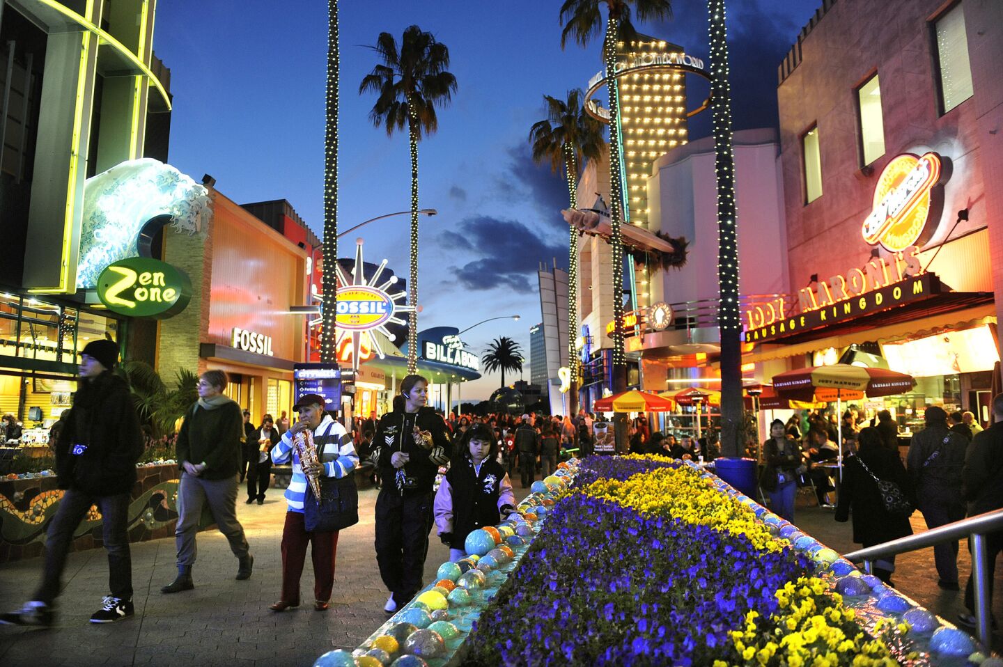 Tourists walk through the Jon Jerde-designed Universal CityWalk in Los Angeles.