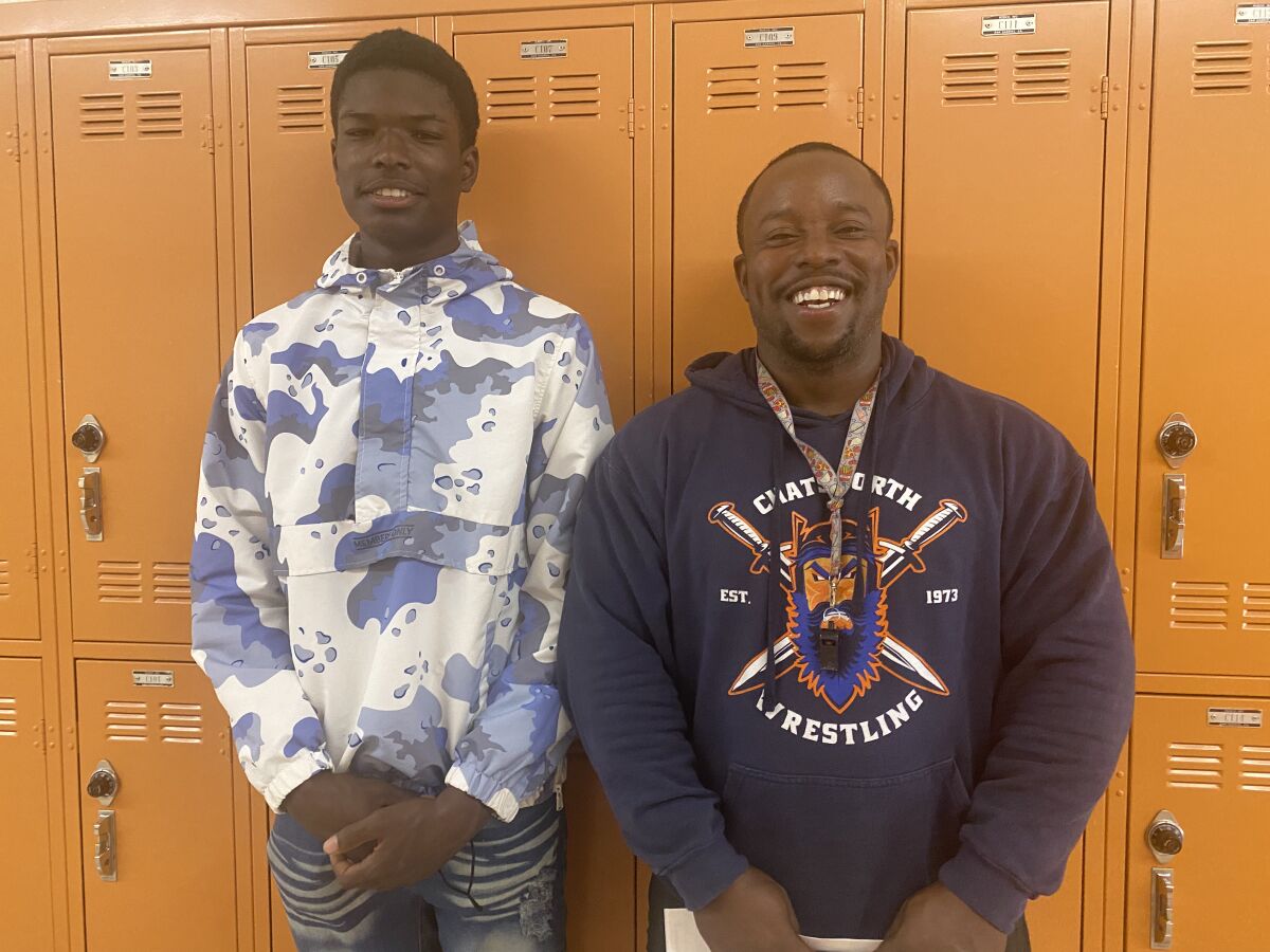 Chatsworth junior football player Rayshaun Tillman (left) and coach Marvin Street, who helped him turn around his life.