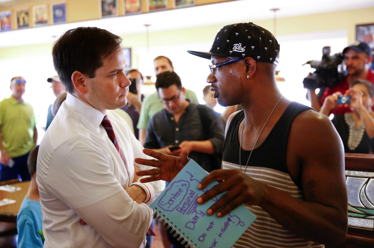 Republican presidential candidate Sen. Marco Rubio of Florida talks with a customer at Tiffany's Family Restaurant in Palm Harbor, Fla., on Saturday.