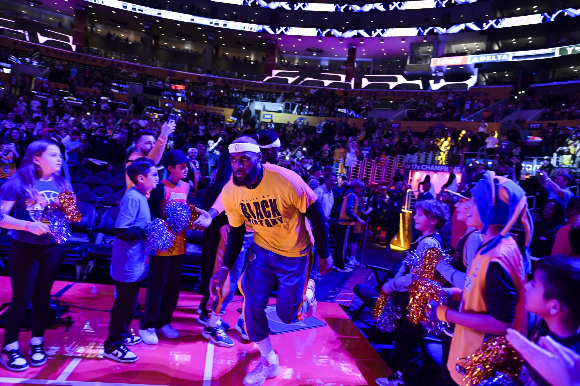 Lakers forward LeBron James runs onto the court for pregame warmups Tuesday night at Crypto.com Arena.