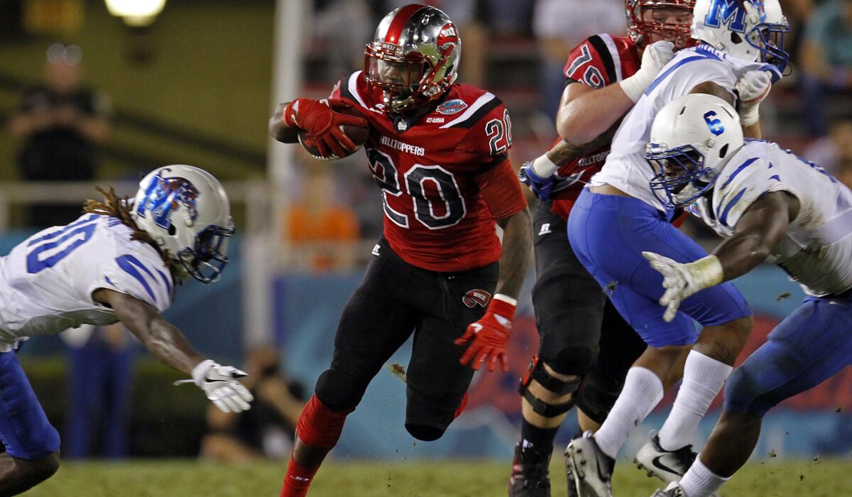 Western Kentucky running back Anthony Wales (20) finds a gap between Memphis defenders during the Boca Raton Bowl on Tuesday.