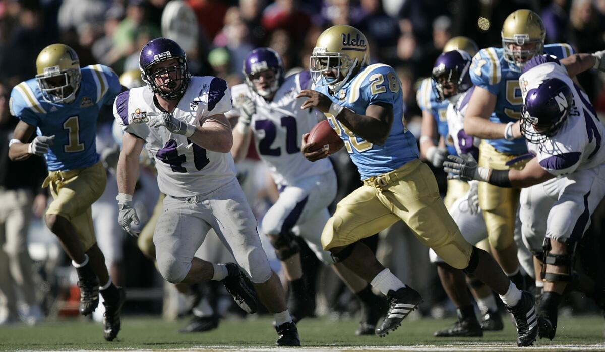 UCLA running back Chris Markey carries the ball 51 yards to set up a late game-tying touchdown during the Bruins' 50-38 win over Northwestern in the 2005 Sun Bowl.