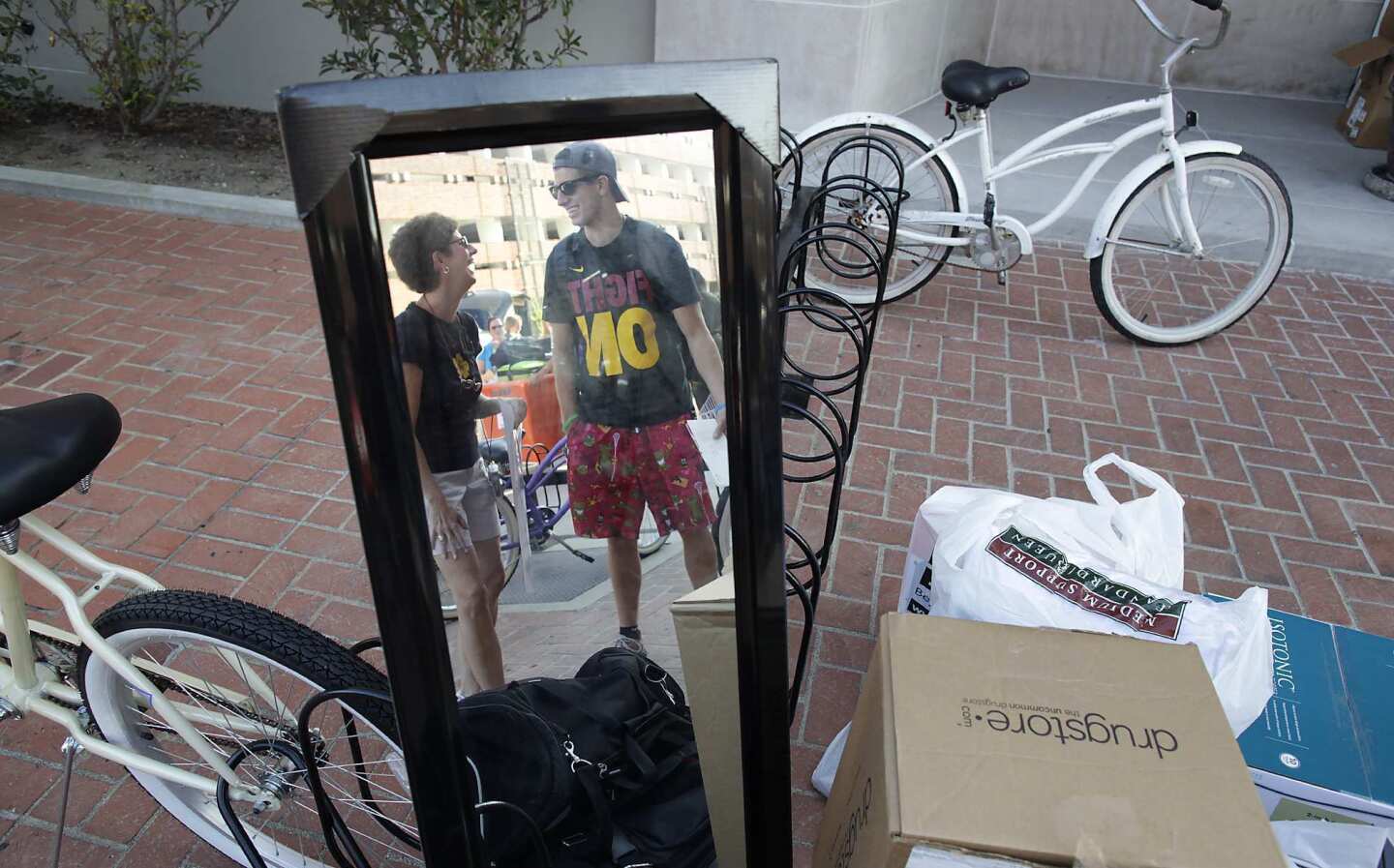 USC freshman Jack Martin, right, gets help from his mother, Karen Martin, as he unloads his belongings at a campus dorm.