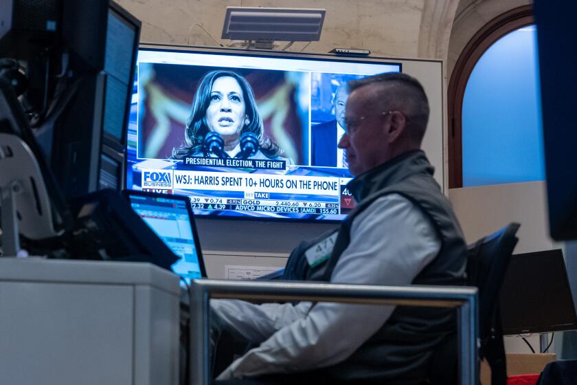 NEW YORK, NEW YORK - JULY 22: Traders work on the floor of the New York Stock Exchange (NYSE) as a picture of Vice President Kamala Harris is displayed on a television screen on July 22, 2024 in New York City. Markets were up in morning trading as the world reacted to the news that U.S. President Joe Biden has ended his re-election campaign and endorsed Vice President Kamala Harris. (Photo by Spencer Platt/Getty Images)