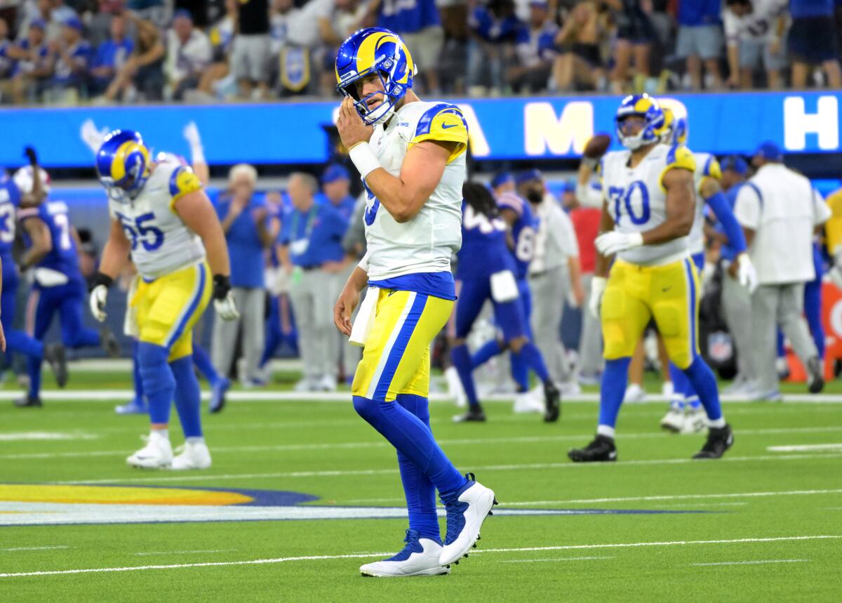 Rams quarterback Matthew Stafford walks off the field after having a pass intercepted.