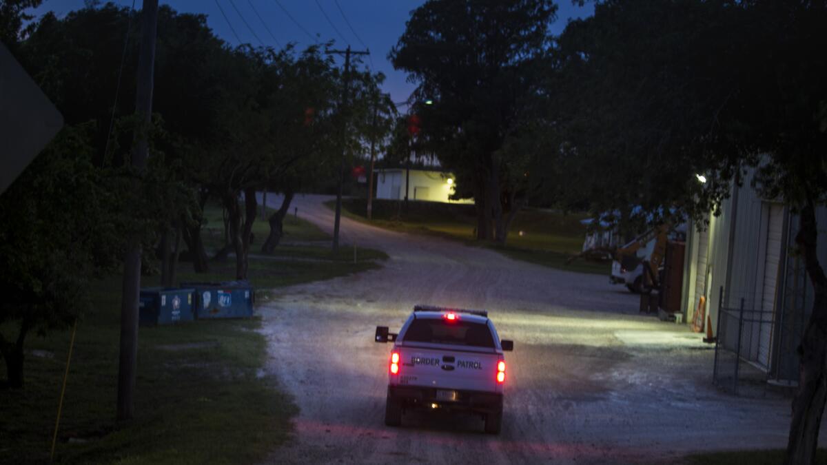 U.S. agents patrol Rio Grande border ranch land on the Mexico side of a fence separating the ranches from the town of Hidalgo, Texas.