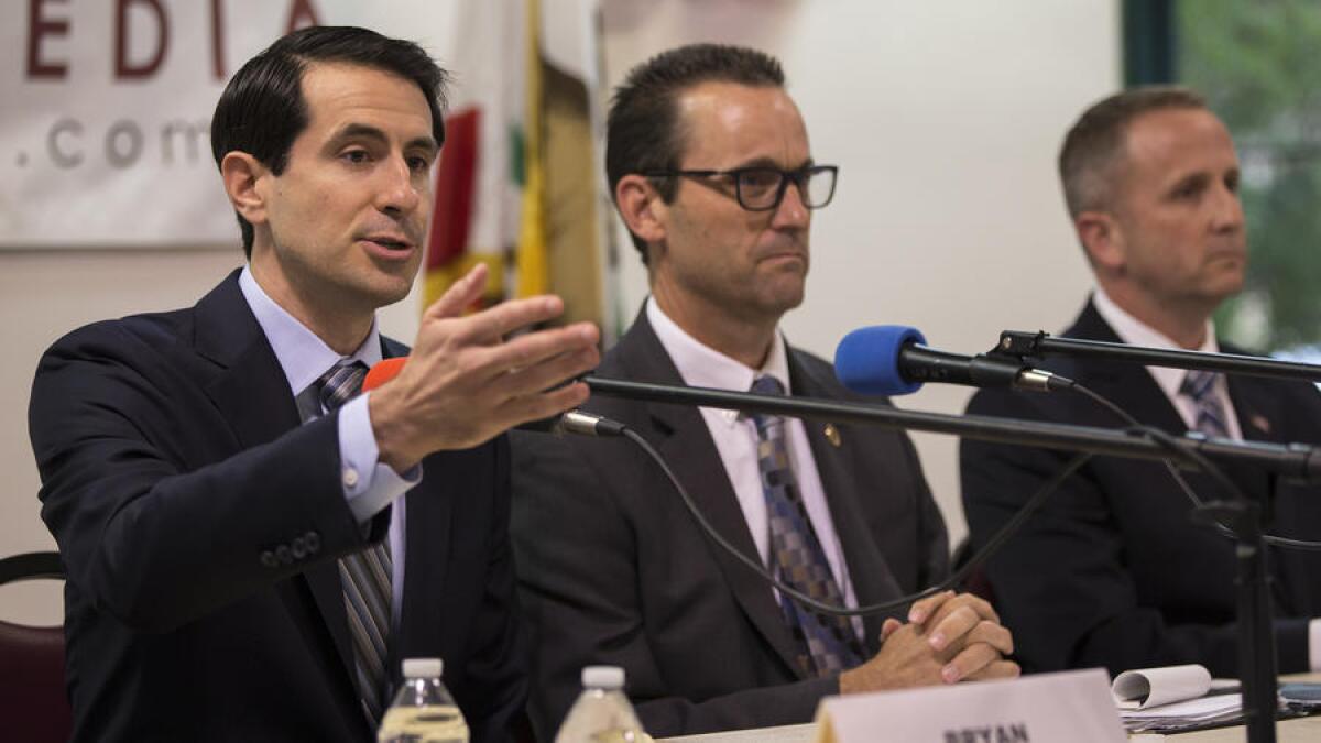 25th Congressional District candidate Bryan Caforio, a Democrat, left, gives his opening statement in a debate against rivals Rep. Steve Knight (R-Palmdale) and LAPD Lt. Lou Vince, a Democrat, at Hart Hall in Newhall. Knight and Caforio are on the ballot this fall.