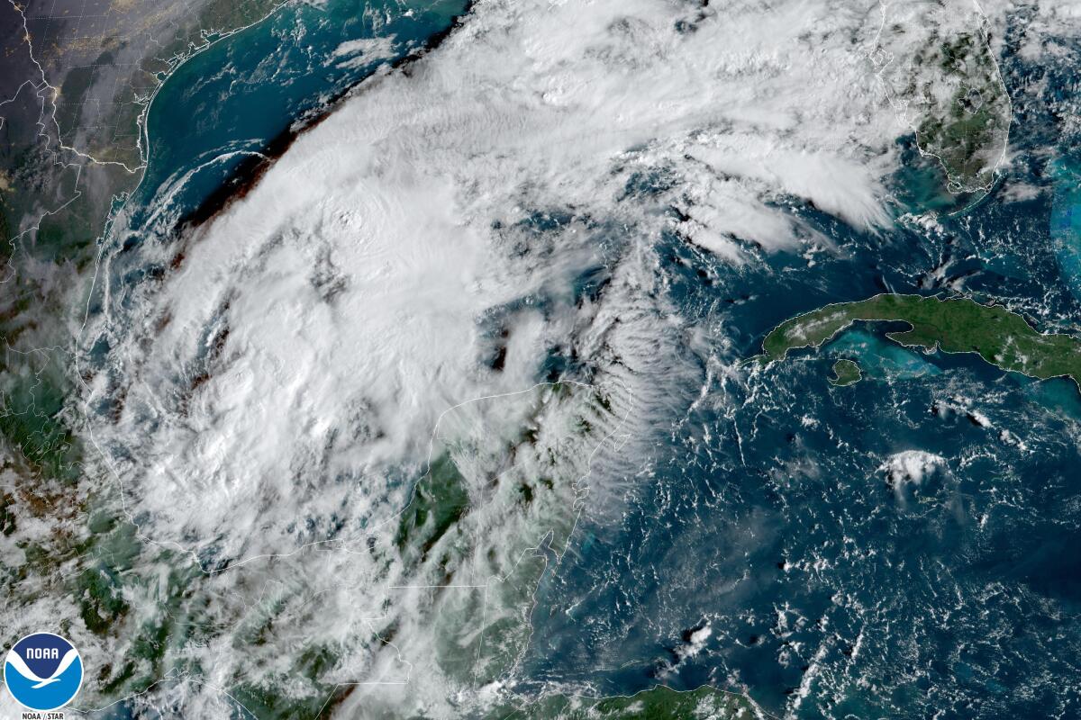 This satellite image taken at 9:30am ET and provided by NOAA shows Tropical Storm Karl in the Gulf of Mexico, on Wednesday, Oct. 12, 2022. Karl grew a little stronger off Mexico’s southern Gulf coast on Wednesday and was expected to approach land by the weekend without gaining hurricane strength. (NOAA via AP)