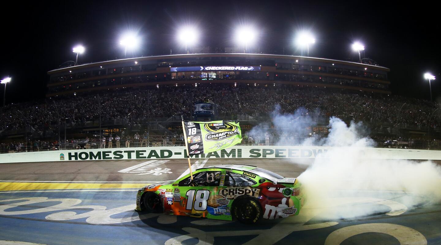 Kyle Busch, driver of the #18 M&M's Crispy Toyota, celebrates winning the series championship and the race with a burnout after the NASCAR Sprint Cup Series Ford EcoBoost 400 at Homestead-Miami Speedway on November 22, 2015 in Homestead, Florida.