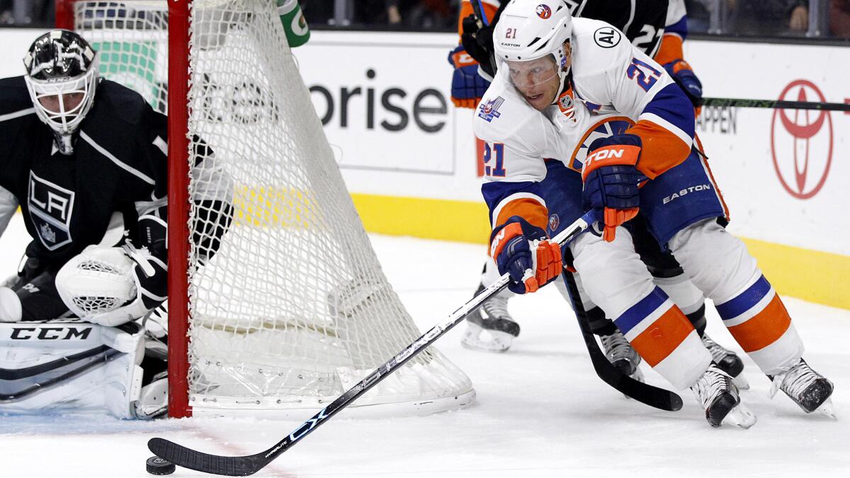 Kings goalie Jhonas Enroth is poised to stop a wrap-around attempt by Islanders right wing Kyle Okposo in the first period Thursday night.