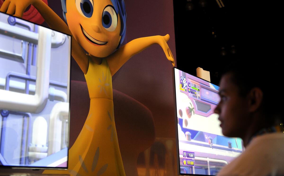 An attendee plays "Disney Infinity 3.0" during the Electronic Entertainment Expo at the Los Angeles Convention Center.