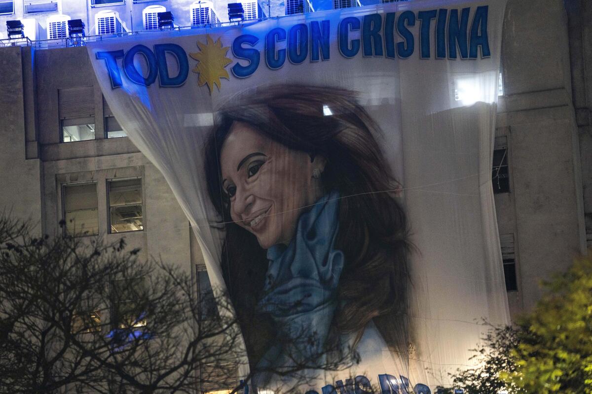 A banner depicting Argentina's Vice President Cristina Fernandez hangs from a government building early Friday, Sept. 2, 2022, hours after a person pointed a gun at her outside her home in Buenos Aires, Argentina. (AP Photo/Rodrigo Abd)