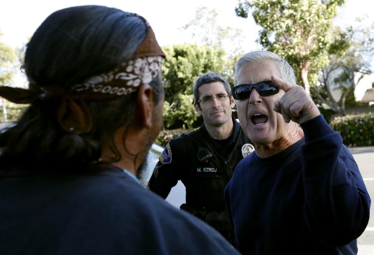 Police keep a close eye on protesters outside the Los Alamitos City Council meeting.