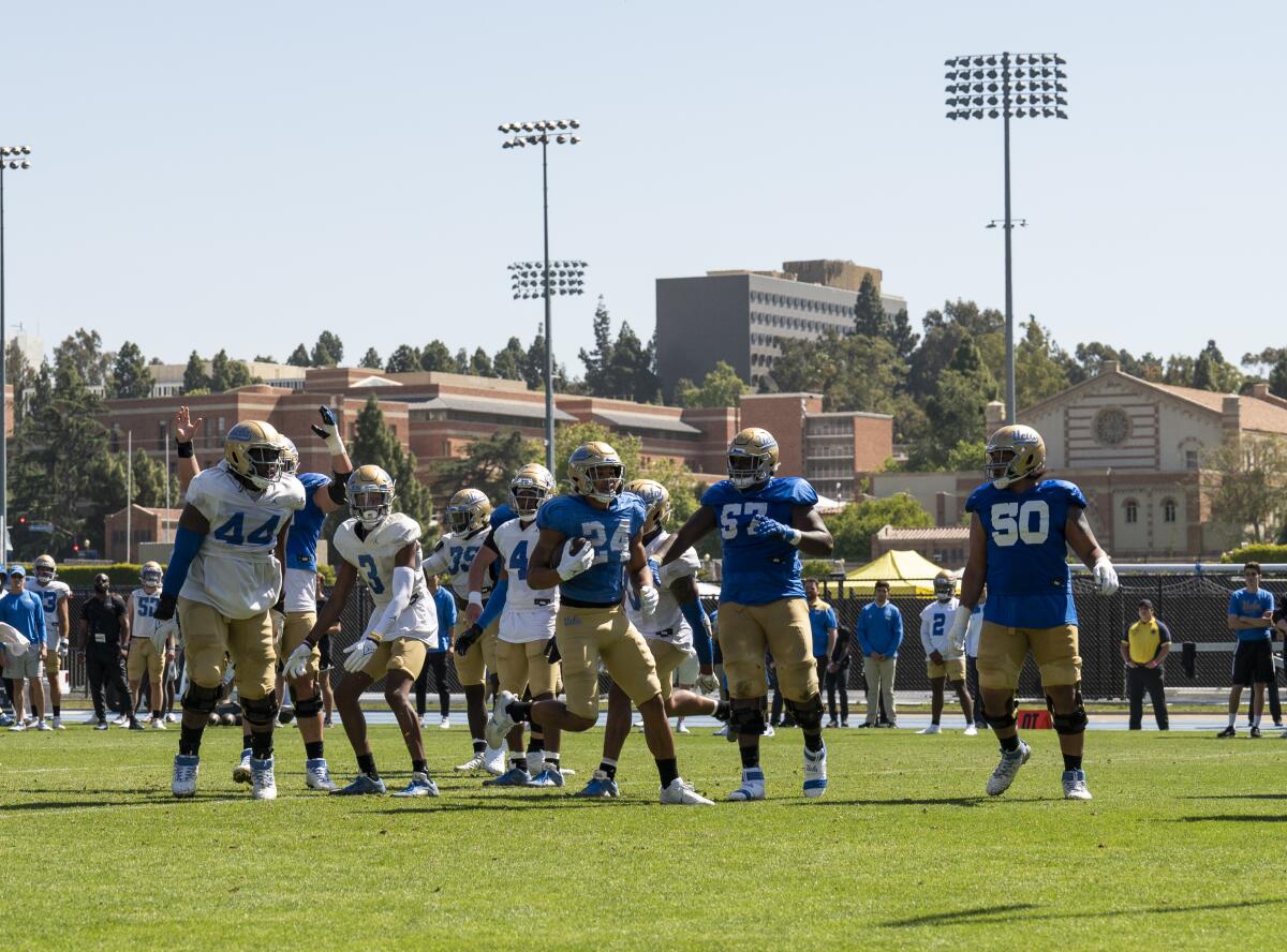 UCLA football players participate during Spring Showcase on the field at Drake Stadium.