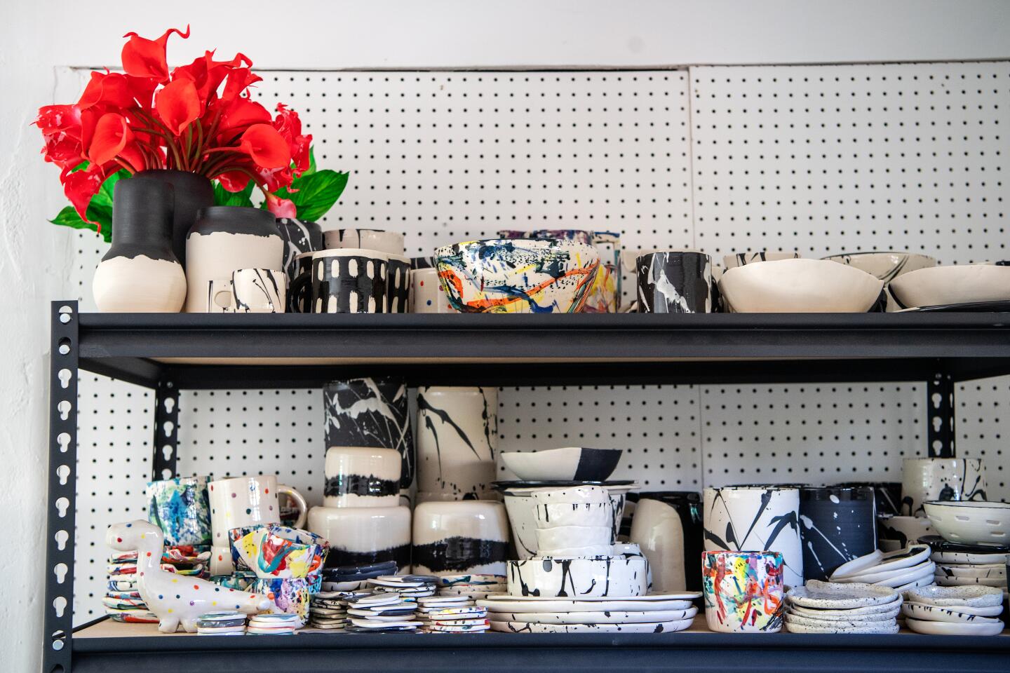 A look at two shelves full of ceramics inside the BTW studio