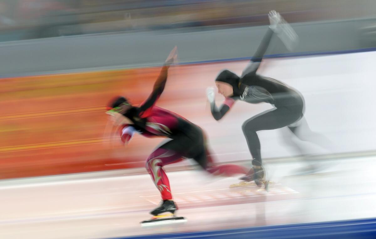 Germany's Jenny Wolf, left and U.S. speed-skater Heather Richardson compete in the Women's Speed Skating 500 m at the Adler Arena during the 2014 Sochi Winter Olympics on Feb. 11, 2014.