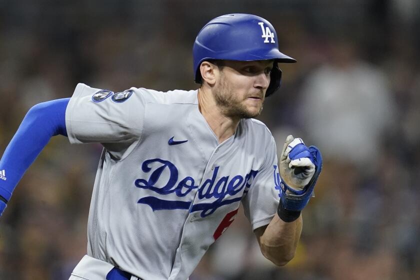 Los Angeles Dodgers' Trea Turner hits a bunt single during the seventh inning in Game 4.