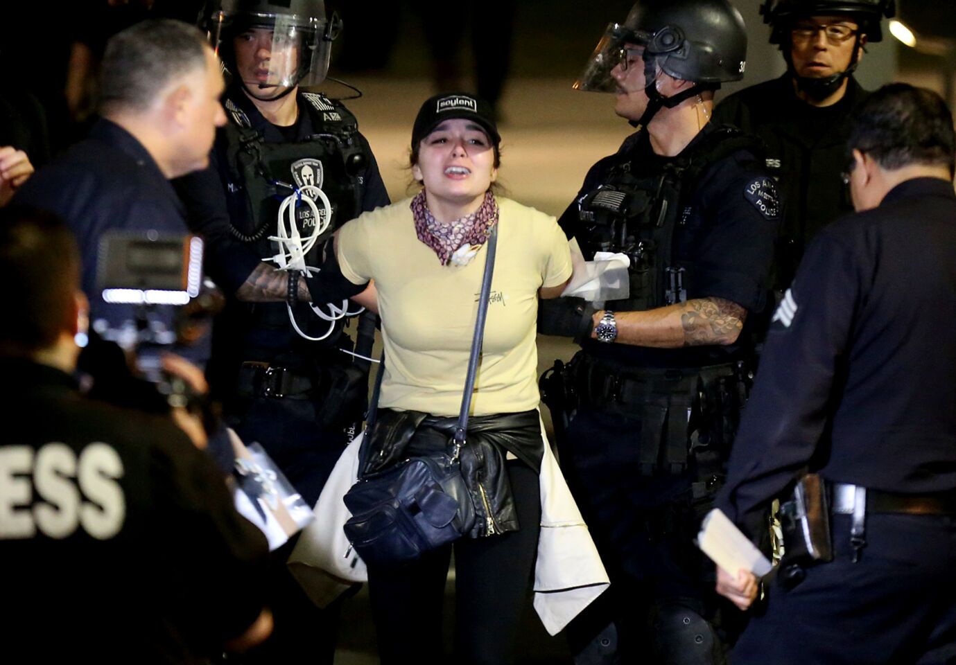 Police arrest an anti-Trump protester in the early morning hours Saturday. The LAPD arrested about 150 people at Grand Park after a night of marching through downtown L.A.