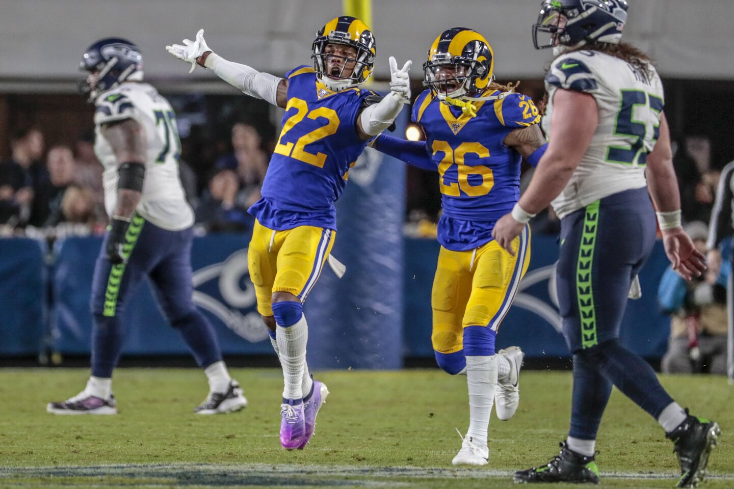 Rams cornerback Troy Hill celebrates with teammate Marqui Christian after intercepting a pass.