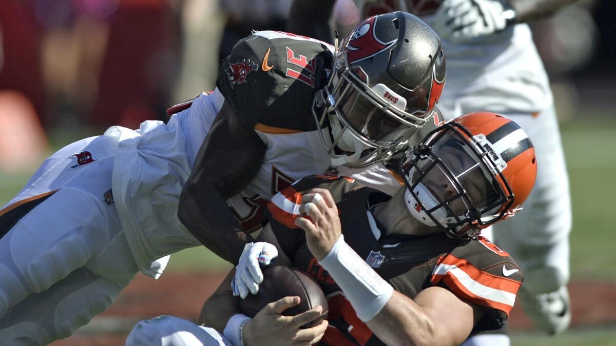 Tampa Bay Buccaneers defensive back Jordan Whitehead (31) hits Cleveland Browns quarterback Baker Mayfield (6).