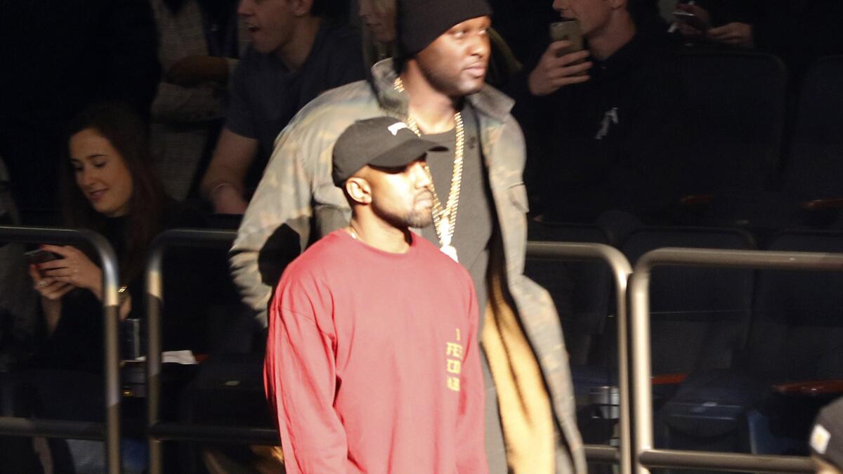 Lamar Odom, background, and Kanye West enter Madison Square Garden for the unveiling of the Yeezy collection and album release for West's latest album, "The Life of Pablo," on , Feb. 11, 2016 during Fashion Week in New York.