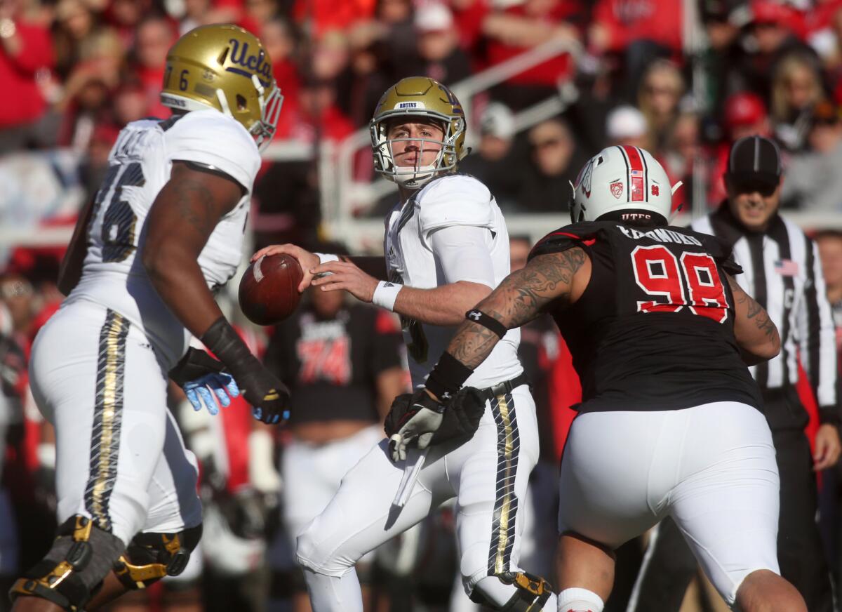 UCLA quarterback Josh Rosen, center, drops back for a pass as Utah defensive tackle Viliseni Fauonuku (98) goes in for a tackle in a 2015 in Salt Lake City.