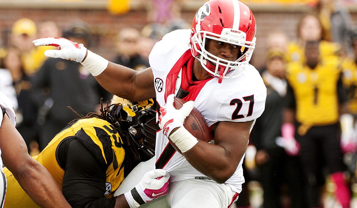 Georgia running back Nick Chubb (27) tries to spin from the grasp of Missouri defensive lineman Markus Golden in the first half Saturday.