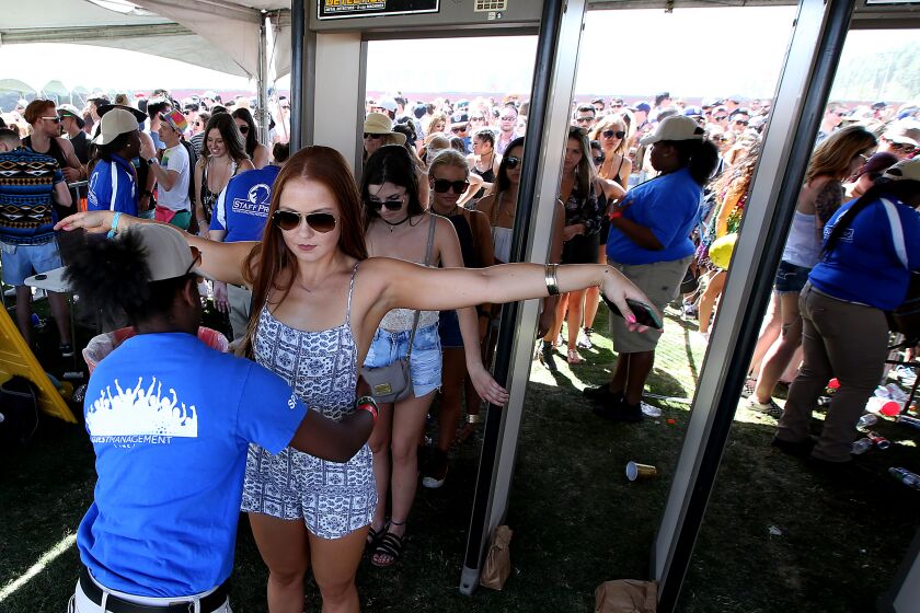 INDIO, CALIF. - APR. 15, 2016. Crowds of people at the Coachella Music and Arts Festival in Indio pass through securiity bag checks, metal detectors and a patdown at the entrance to the concert grounds on Friday, Apr. 15, 2016. (Luis Sinco/Los Angeles Times)