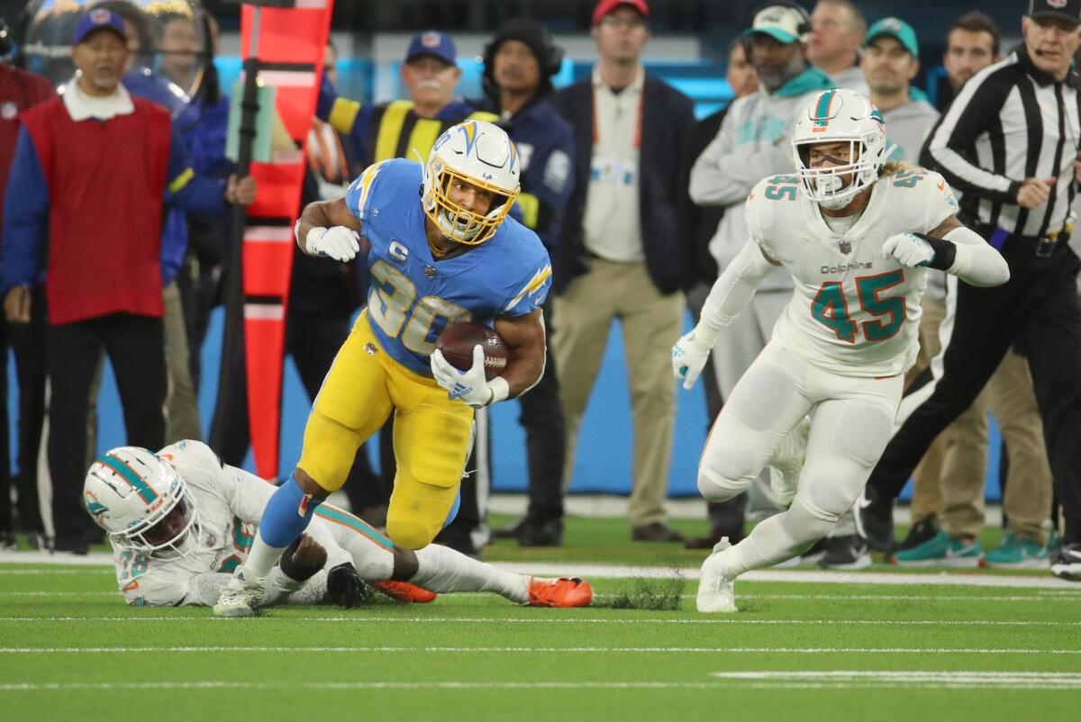The Chargers' Austin Ekeler breaks free against the Dolphins secondary. 