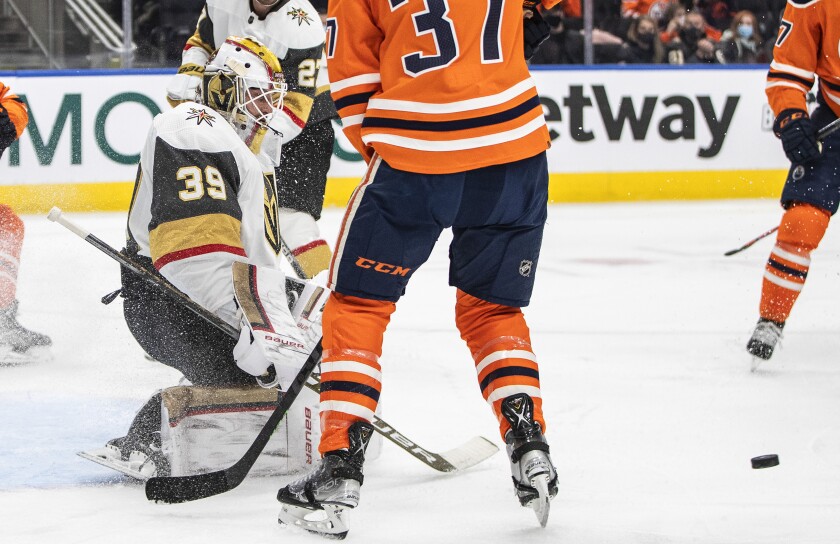 Vegas Golden Knights goalie Laurent Brossoit (39) makes a save against the Edmonton Oilers during the second period of an NHL hockey game Tuesday, Feb. 8, 2022, 2022 in Edmonton, Alberta. (Jason Franson/The Canadian Press via AP)