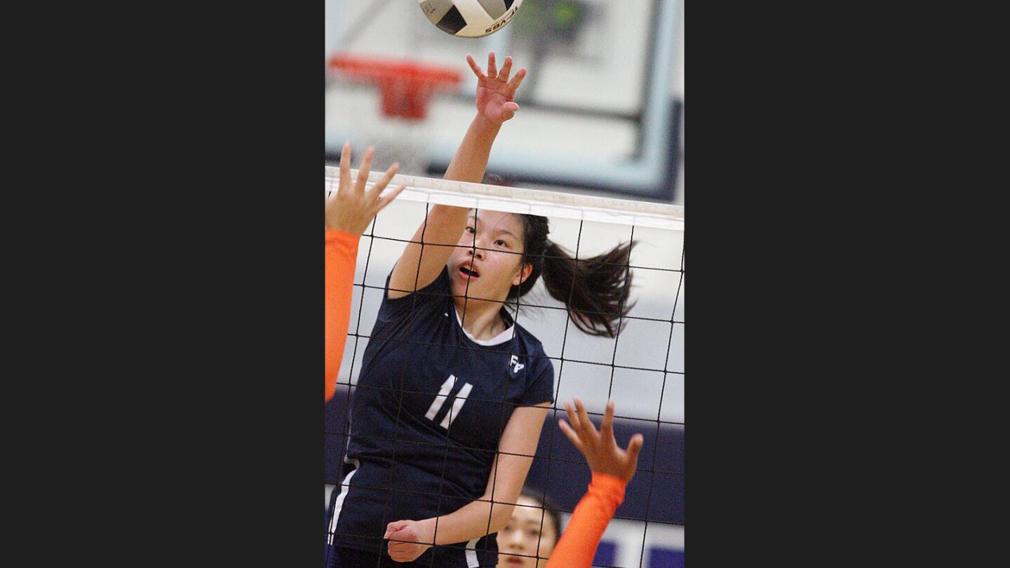 Flintridge Prep's Kaitlyn Chen hits a kill against Pasadena Poly in a Prep League girls' volleyball match at Flintridge Prep in La Canada Flintridge on Wednesday, September 20, 2017.