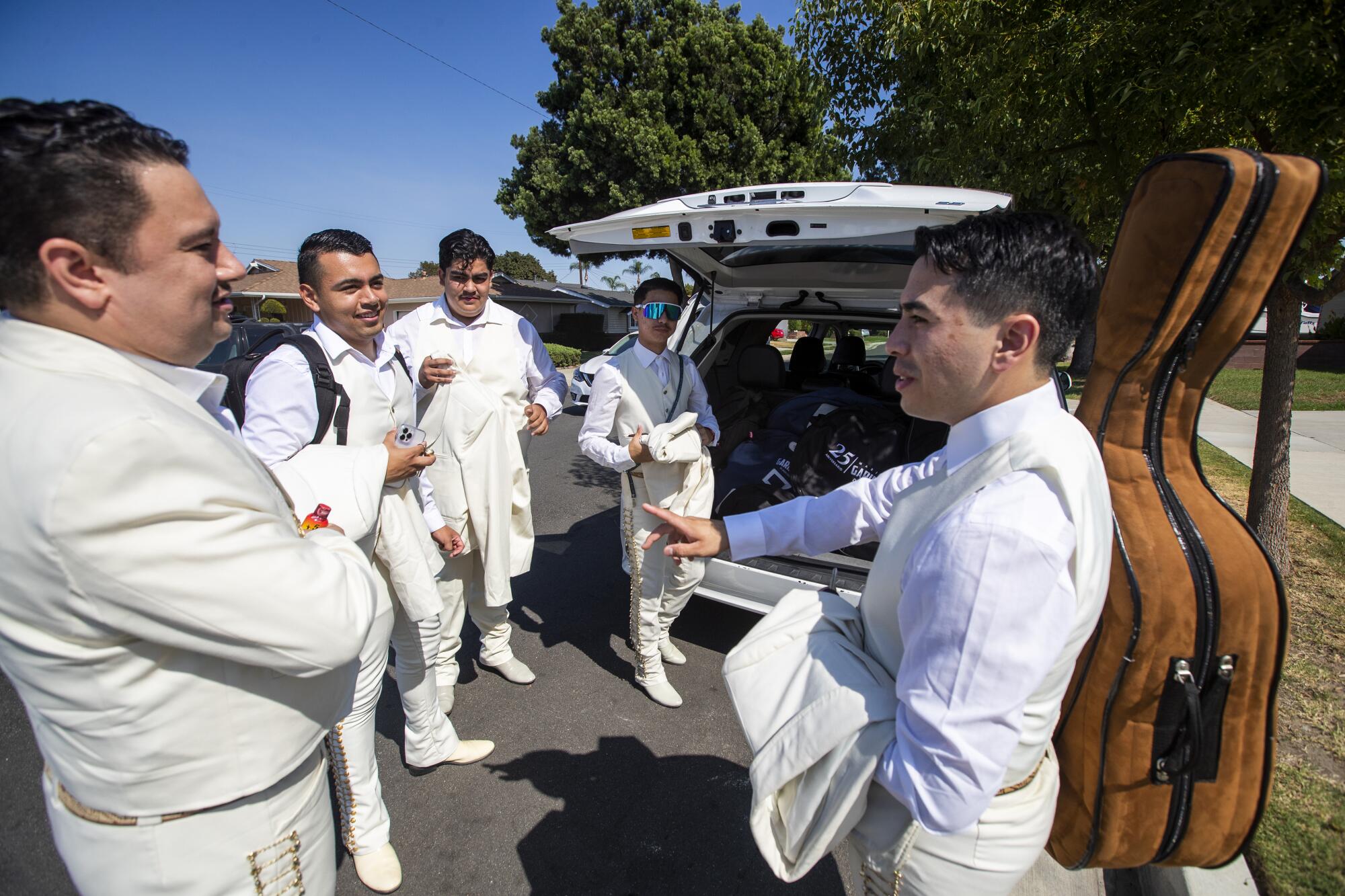 Mariachi Garibaldi de Jaime Cuellar members load up in the van as they carpool to Dodger Stadium