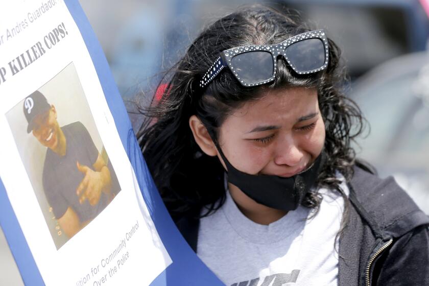 GARDENA, CALIF. - JUNE 19, 2020. Jennifer Guardado, sister of Andres Guardado, is overcome with emotion on Firiday afernoon, June 19, 2020, as she visits the location in Gardena where the 18-year-old L:atino man was shot and killed by L.A. County Sheriff's deputies. Family members and community activists said Guardado was working as a security guard in a body shop when the violent encounter with police happened on Thursday, June 18, 2020. (Luis Sinco/Los Angeles Times)