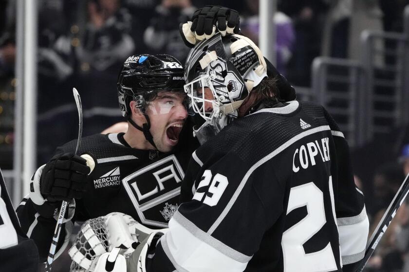 Los Angeles Kings left wing Kevin Fiala, left, and goaltender Pheonix Copley celebrate after a win over the Montreal Canadiens during an NHL hockey game Saturday, Nov. 25, 2023, in Los Angeles. (AP Photo/Marcio Jose Sanchez)