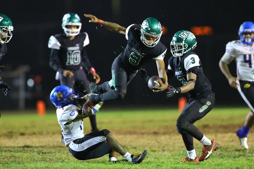 Ja'Marion Broughton of Dorsey goes airborne against Crenshaw.