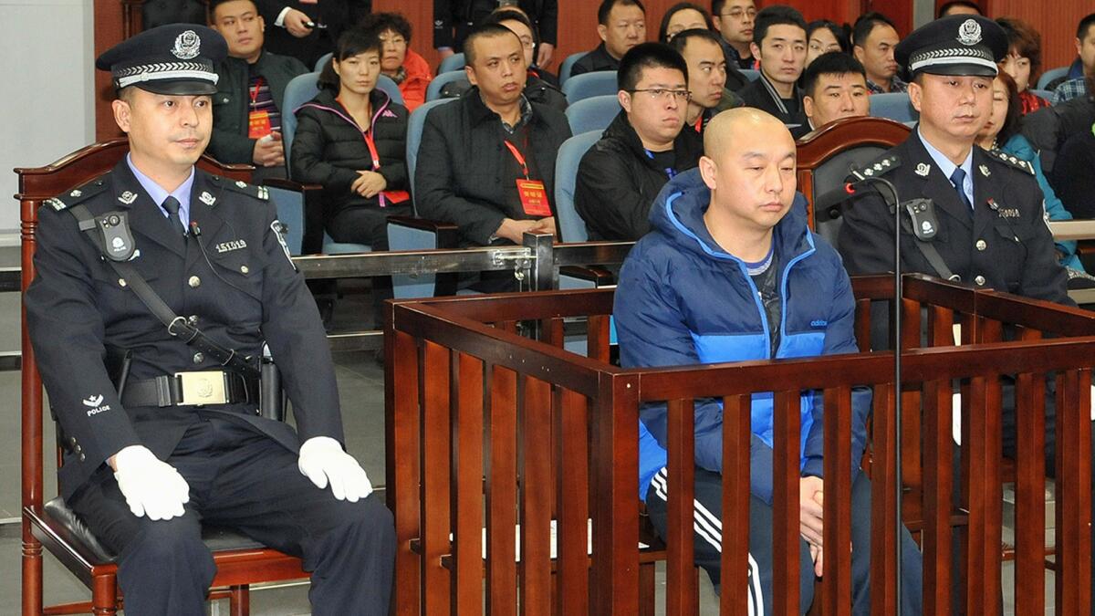 A court in China's Inner Mongolia region sentenced Zhao Zhihong, center, to death in 2015 for the killing of 10 people and the rape of 13 women and girls between 1996 and 2005, state-run media reported (AFP / Getty Images)