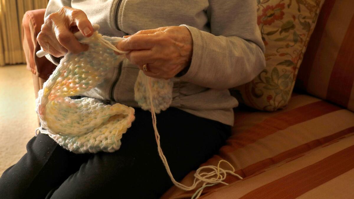 Mary Janacek crochets a baby blanket in her El Cajon home. Over the past 10 years she has made and donated more than 600 for babies at Foothill United Methodist Church in La Mesa.