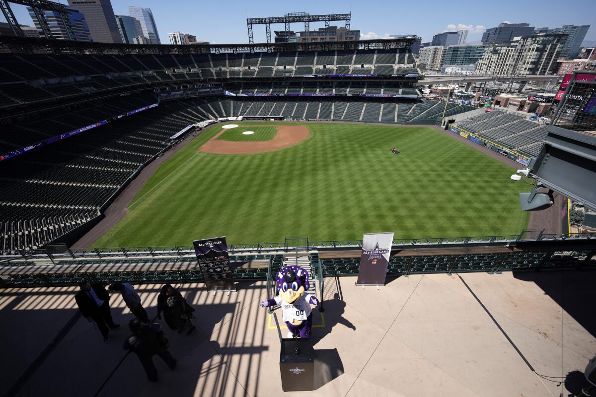 Dinger, mascot of the Colorado Rockies, speaks during a news conference.