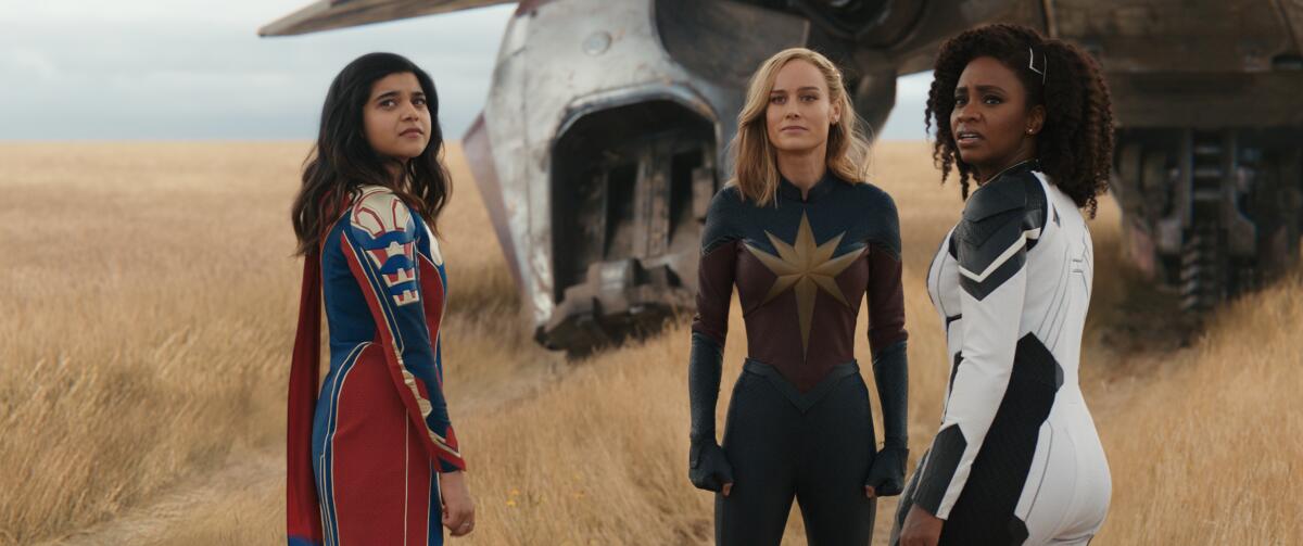 Three women dressed as superheroes in the film "The Marvels."  