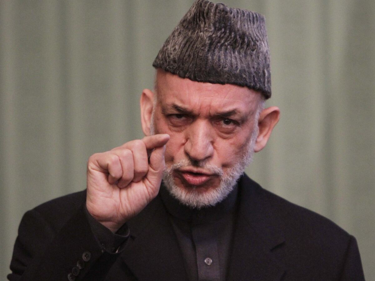 Afghan President Hamid Karzai speaks to journalists during a press conference in Kabul. Karzai said that Washington needs to make concrete steps towards peace with the Taliban before Afghanistan will sign an agreement to allow a continued U.S. military presence in his country.