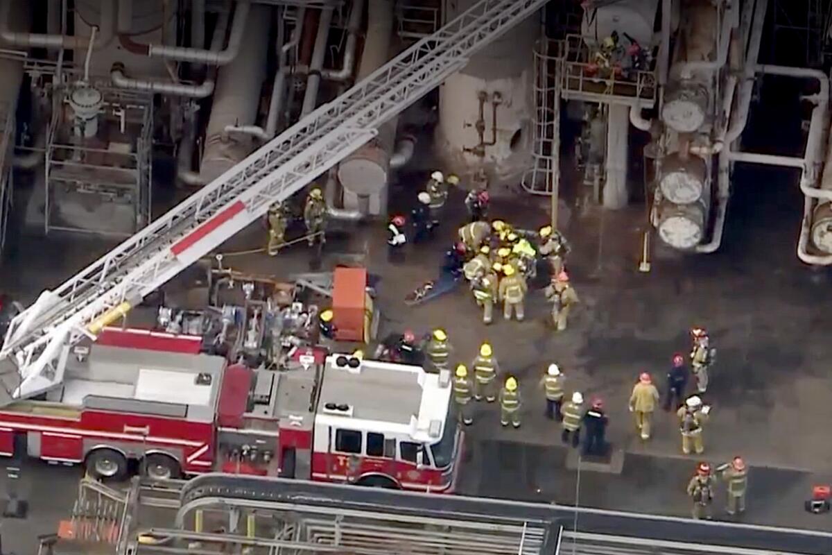 An aerial frame of a rescue operation by firefighters at a refiner.
