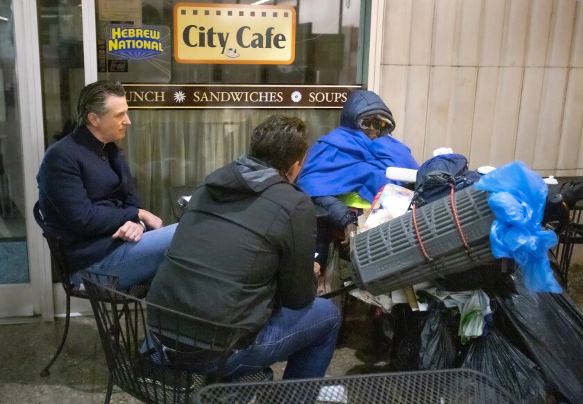 Gov. Gavin Newsom and county Board of Supervisors Chairman Nathan Fletcher talk with a man during the 2020 homeless count.