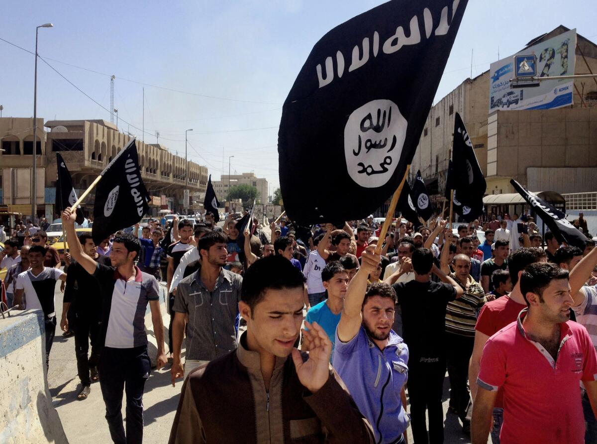 Pro-Islamic State demonstrators in front of the provincial government headquarters in Mosul, Iraq, on June 16, 2014.