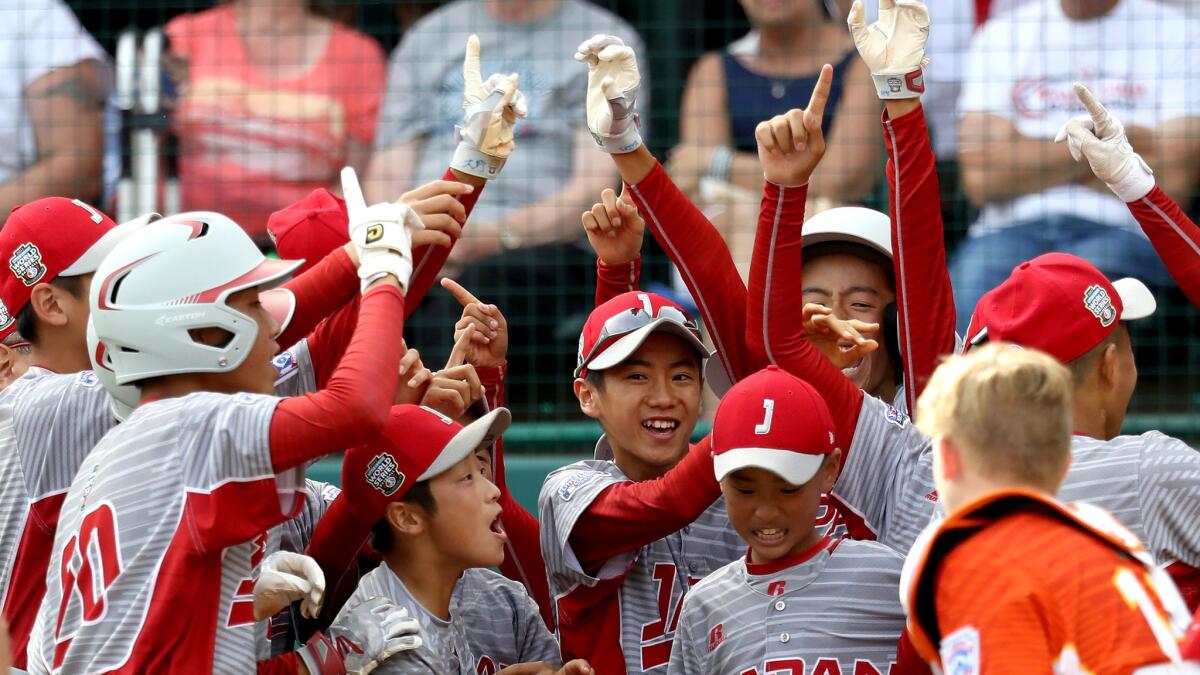 Japan players celebrate after scoring the game-ending run against Lufkin, Texas, in the championship game of the Little League World Series on Sunday.